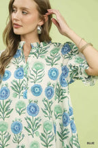 Blue floral babydoll dress closeup, puff sleeve and V-neck with ruffled trim