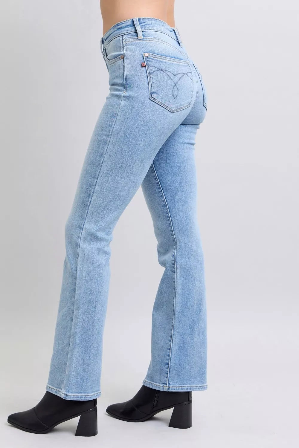 Light wash mid-rise bootcut jeans with curved yoke seam and back pocket stitching