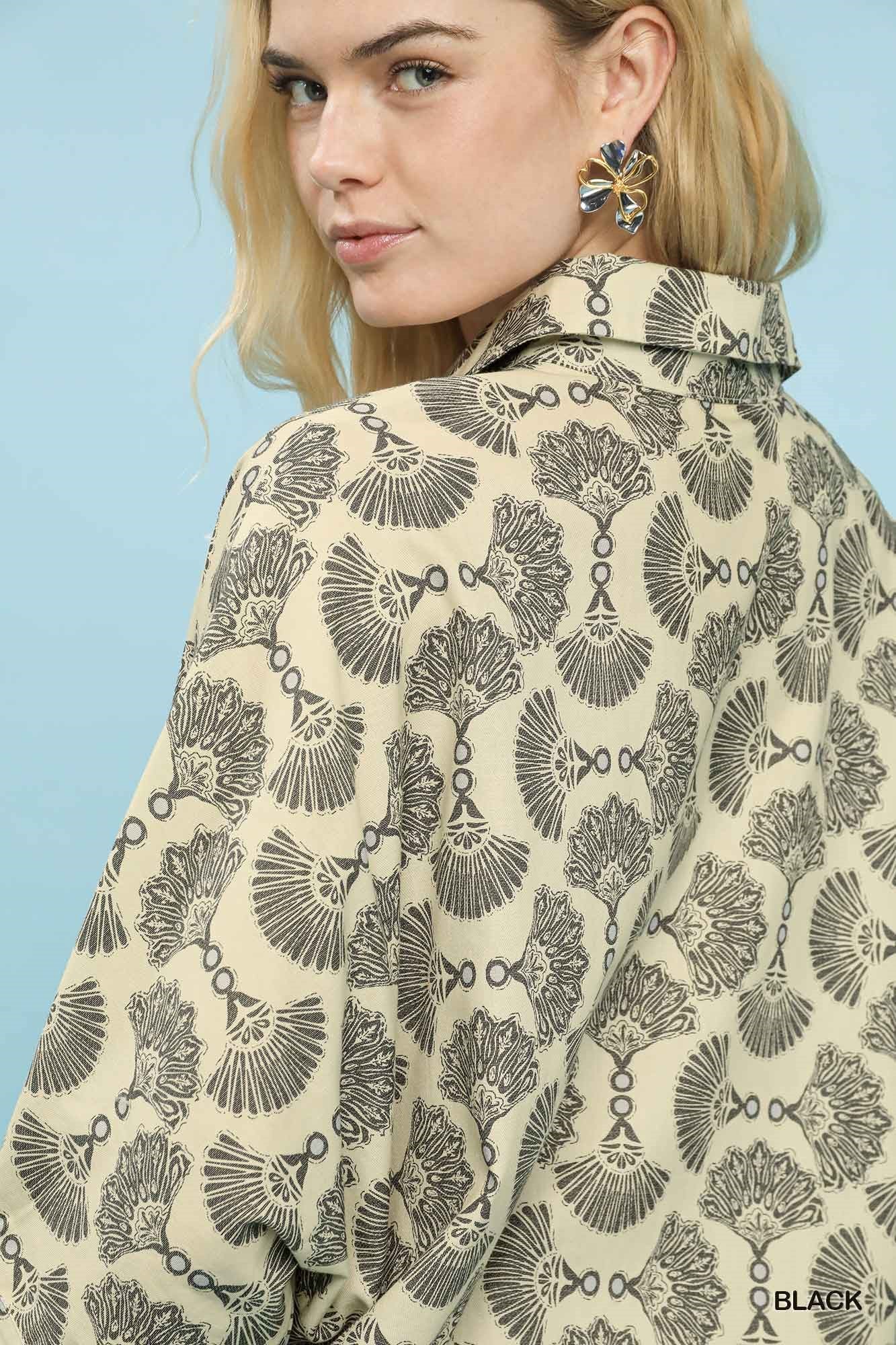 Close-up of printed cotton button-down blouse collar and dark motif pattern