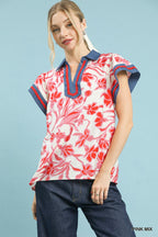 Floral flutter top in pink and white with red blossoms and navy V-neck trim