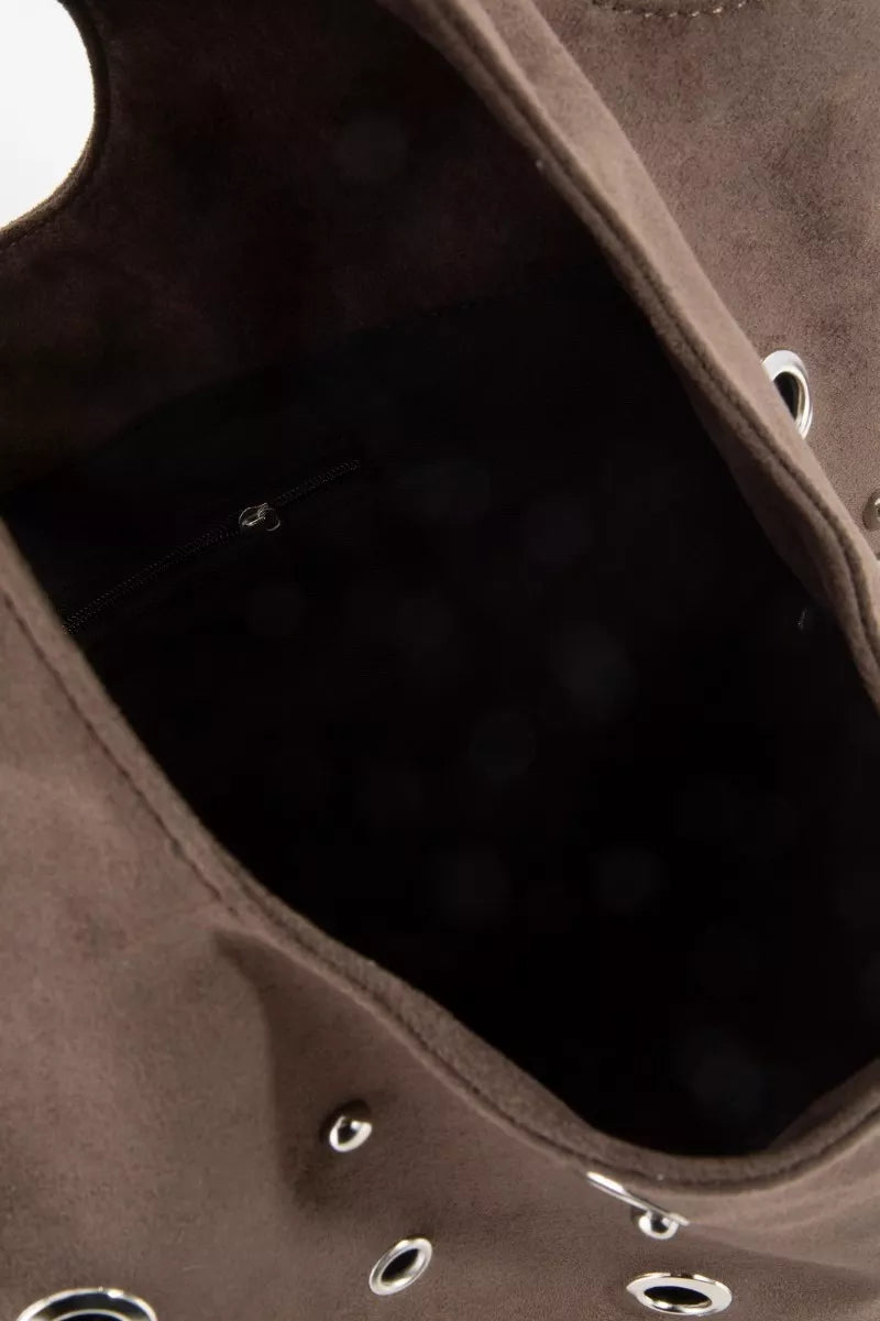 Interior view of dark brown suede tote with silver grommet trim along the opening