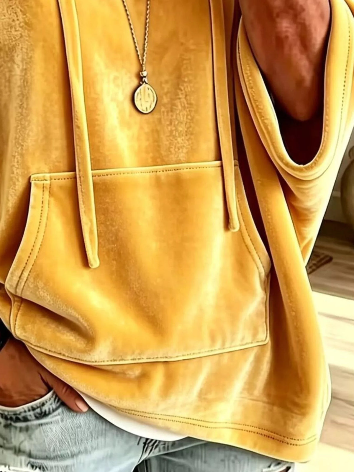 Yellow velvet kangaroo pocket hoodie front detail with drawstring and pouch pocket.