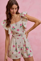 Ivory floral print denim romper with square neckline, ruffled sleeves, and belted waist