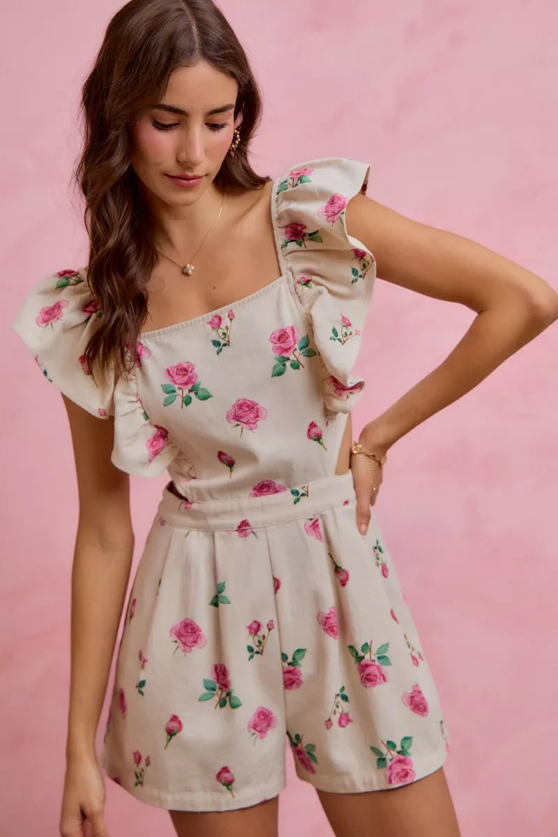 Ivory floral print denim romper with square neckline, ruffled sleeves, and belted waist