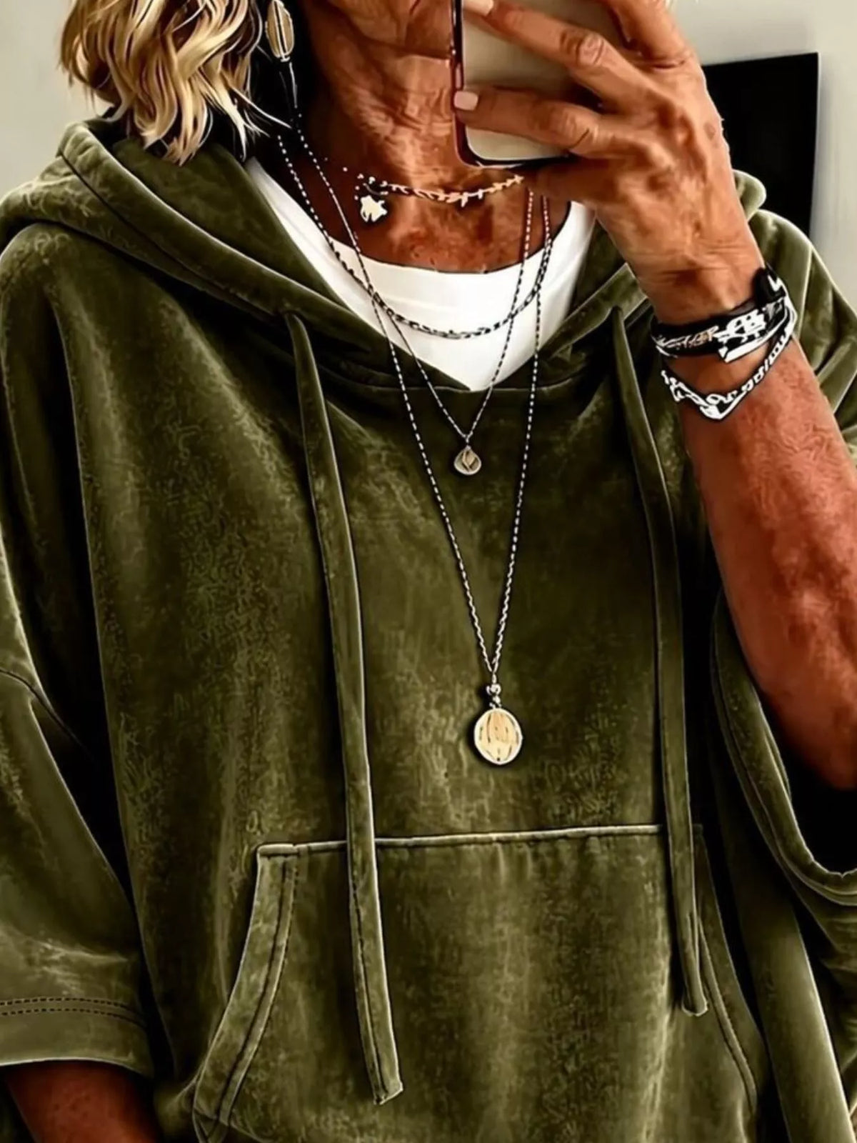 Olive velvet hoodie close-up with front kangaroo pocket and drawstring hood.