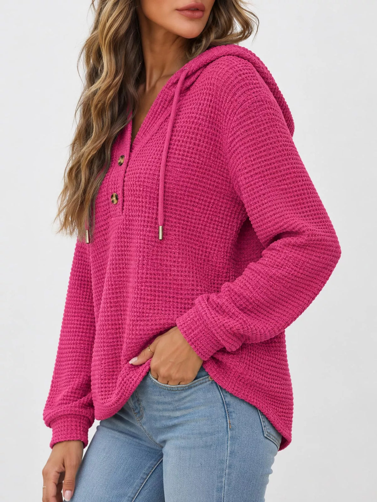 Waffle-knit button hoodie in fuchsia pink, hood with drawstrings and button placket.