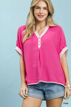 Pink oversized top with V-neck, button placket, and contrast stripe trim at sleeves