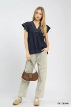 Dark denim cap-sleeve V-neck top worn with light cargo pants