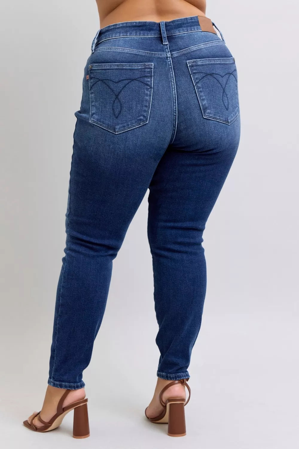 Thermal skinny jeans with high waist, dark blue denim, back view with pocket stitching