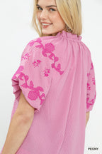 Peony pink embroidered flutter-sleeve top close-up with ruffled gathered neckline