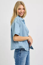 Light blue denim oversized cropped half-sleeve shirt, side view with button placket