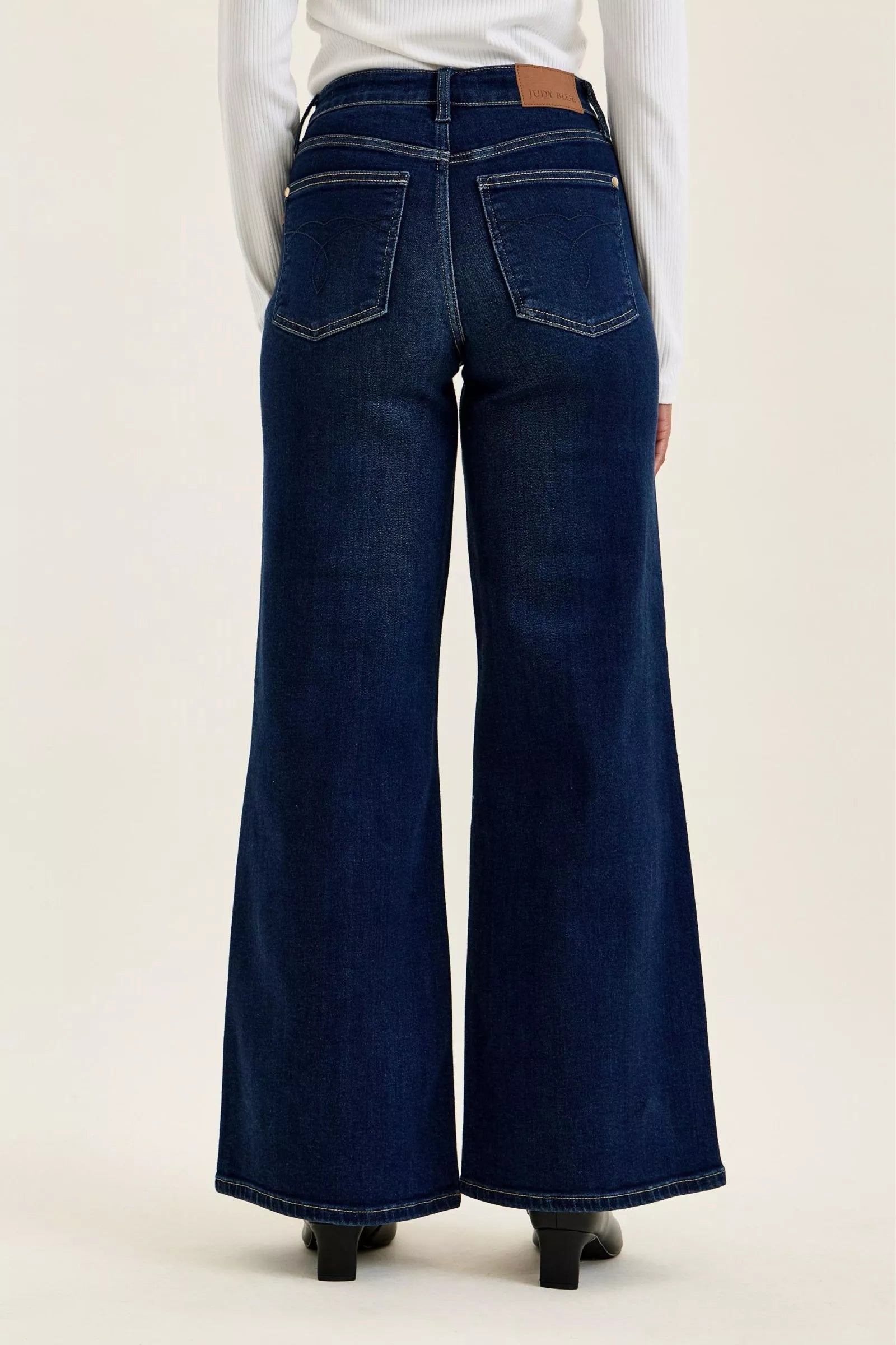 Dark wash wide-leg jeans back view with yoke and patch back pockets