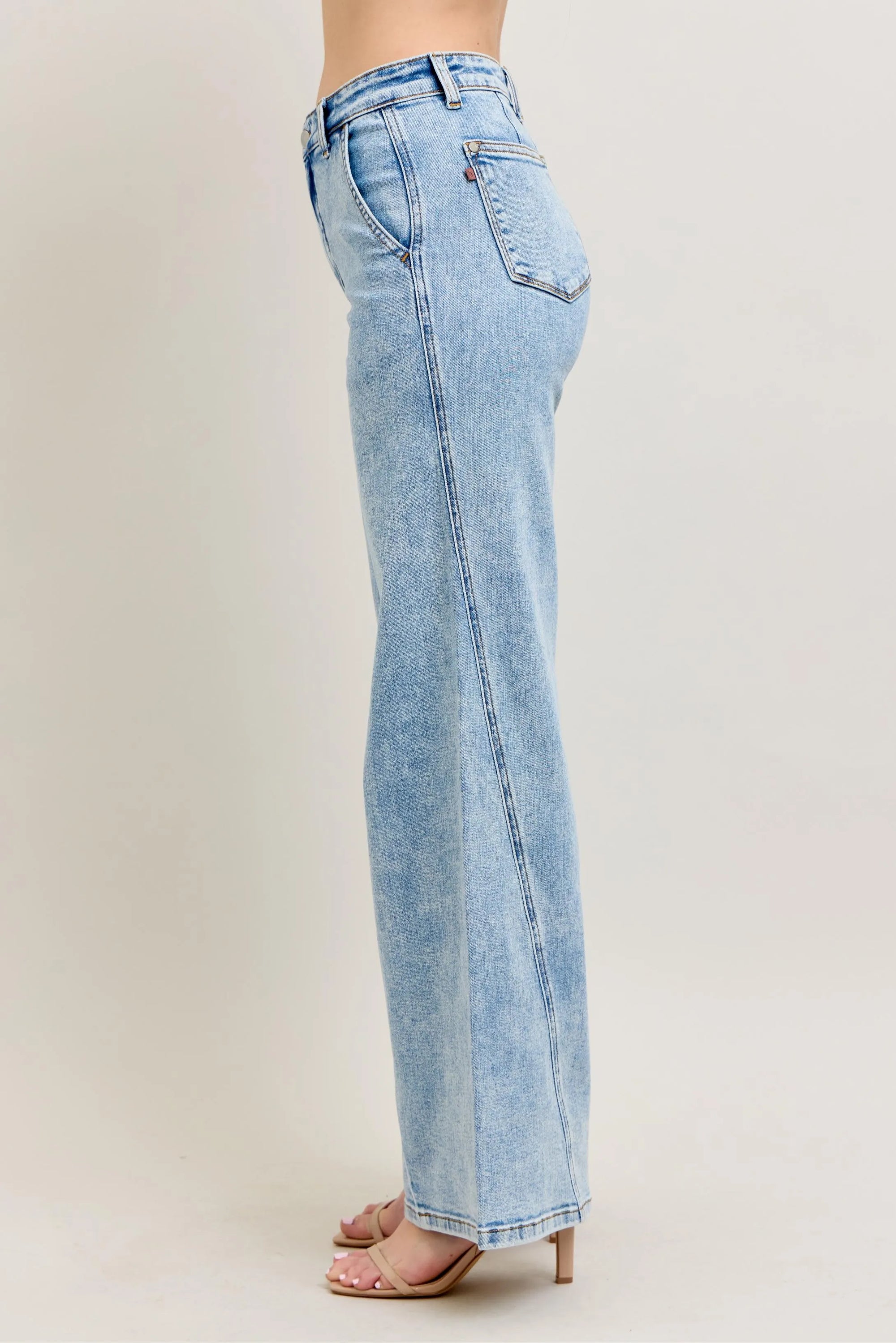 Plus size wide-leg jeans in light wash denim, side view with ankle-length hem