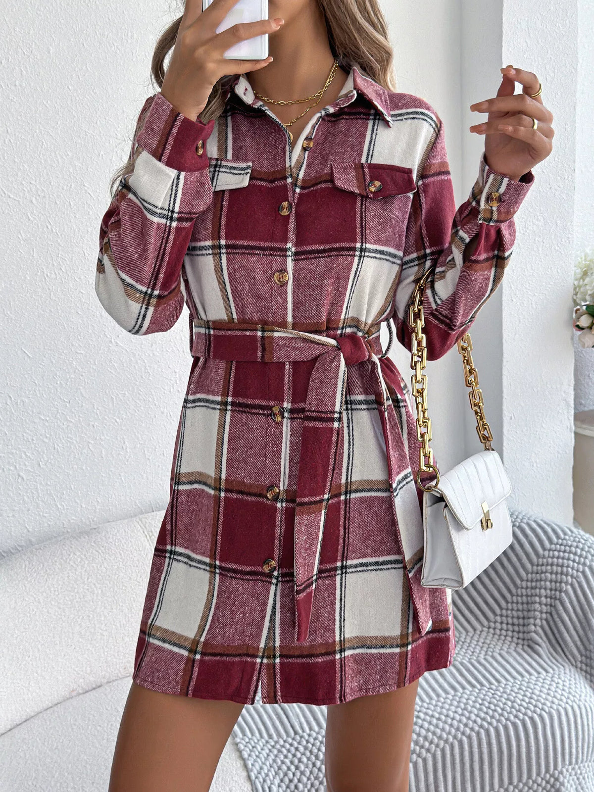 Burgundy plaid belted shirt dress with long sleeves, button front, shirttail hem.