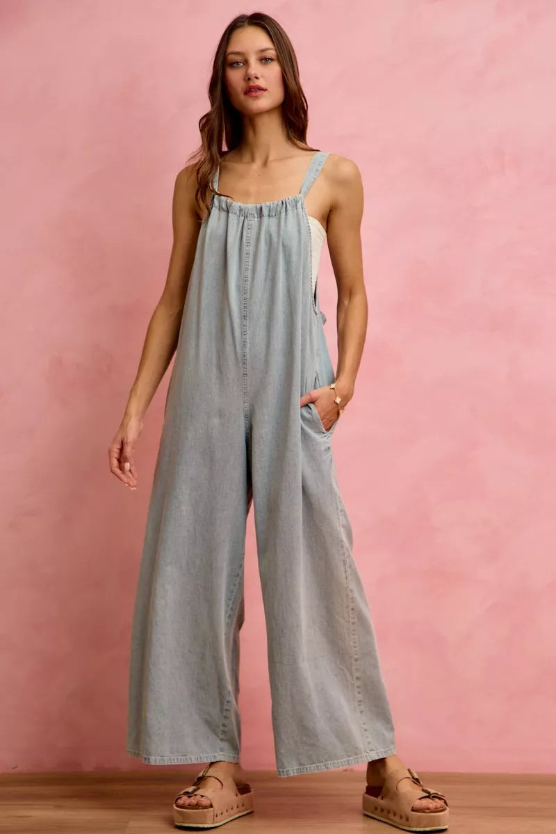 Light blue denim wide-leg overalls with gathered bodice and spaghetti straps
