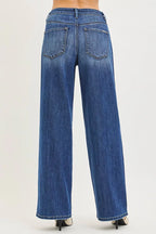 Women’s slouchy baggy jeans, dark blue denim, back view with two patch pockets