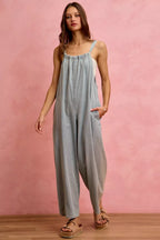 Light blue denim wide-leg overalls with square neckline, thin straps, and front pockets