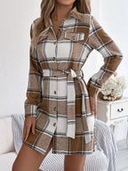 Brown and white plaid shirt dress with button front, long sleeves, and tied belt