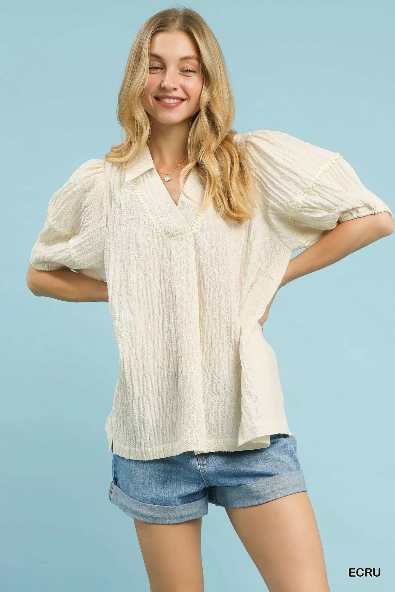 Ecru textured puff-sleeve blouse with V-neck and gathered front yoke