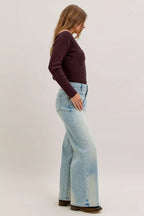 Light blue high-waist straight jeans side view with belt loops and wide straight hem