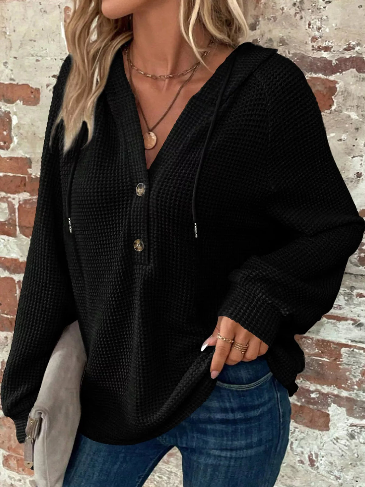 Black waffle-knit button hoodie with hood, front snaps, and long sleeves