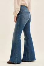 High-waist flare jeans in blue denim, side profile with front seam details and belt loops