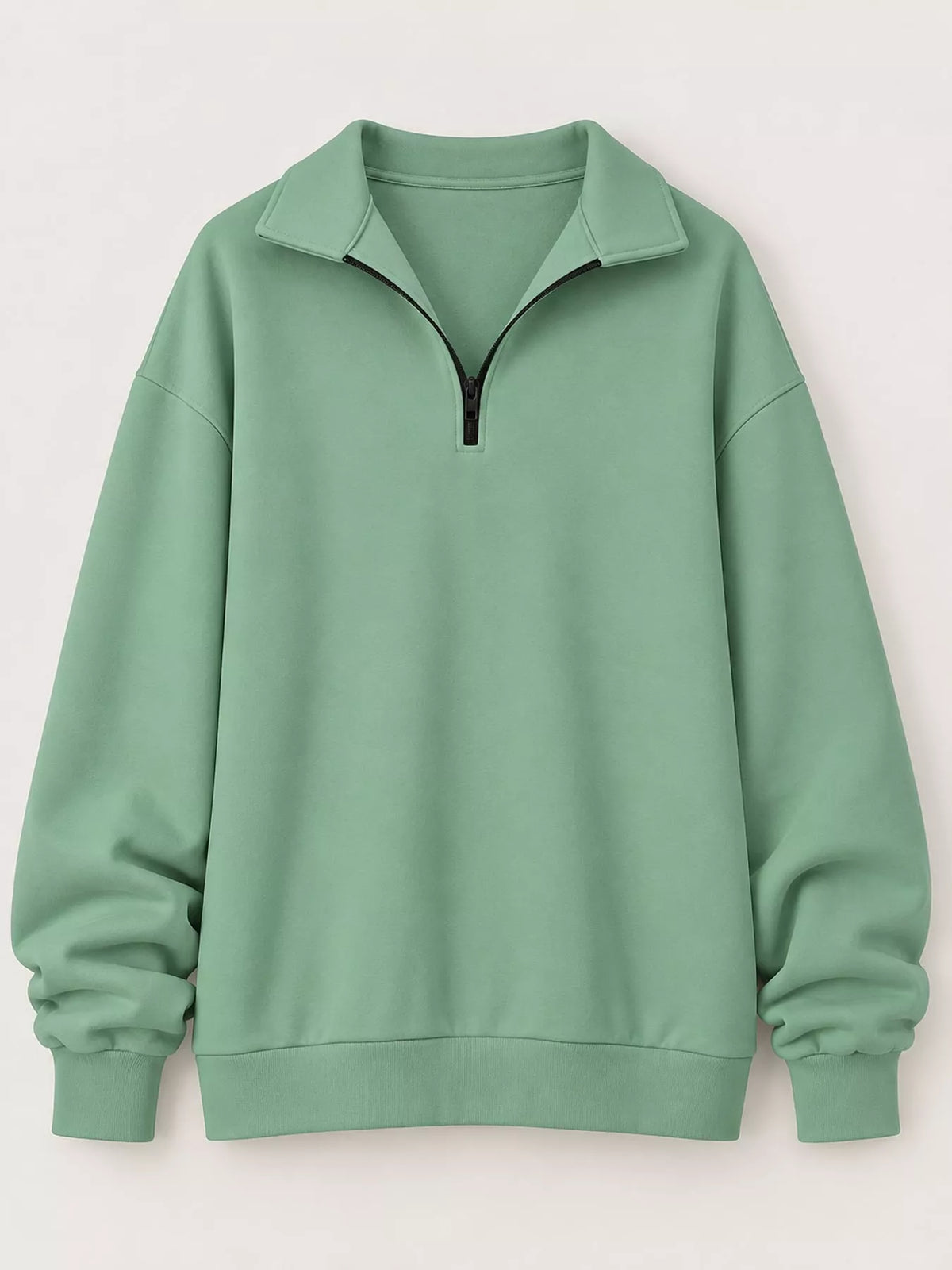 Light green zip-neck sweatshirt with black half-zip and relaxed oversized silhouette