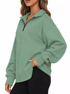 Light green oversized zip-neck sweatshirt with black half-zip and ribbed hem cuffs