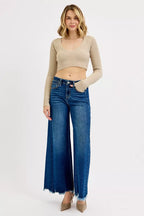 Women’s high-rise wide-leg jeans in blue wash denim, frayed hem and button closure