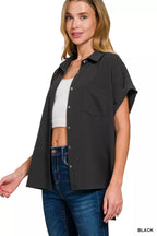 Black button-down blouse with short sleeves, collar, chest pocket, and curved hem