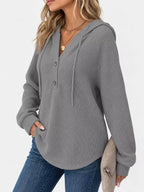 Gray waffle-knit button hoodie on model, hooded neckline with three-button placket