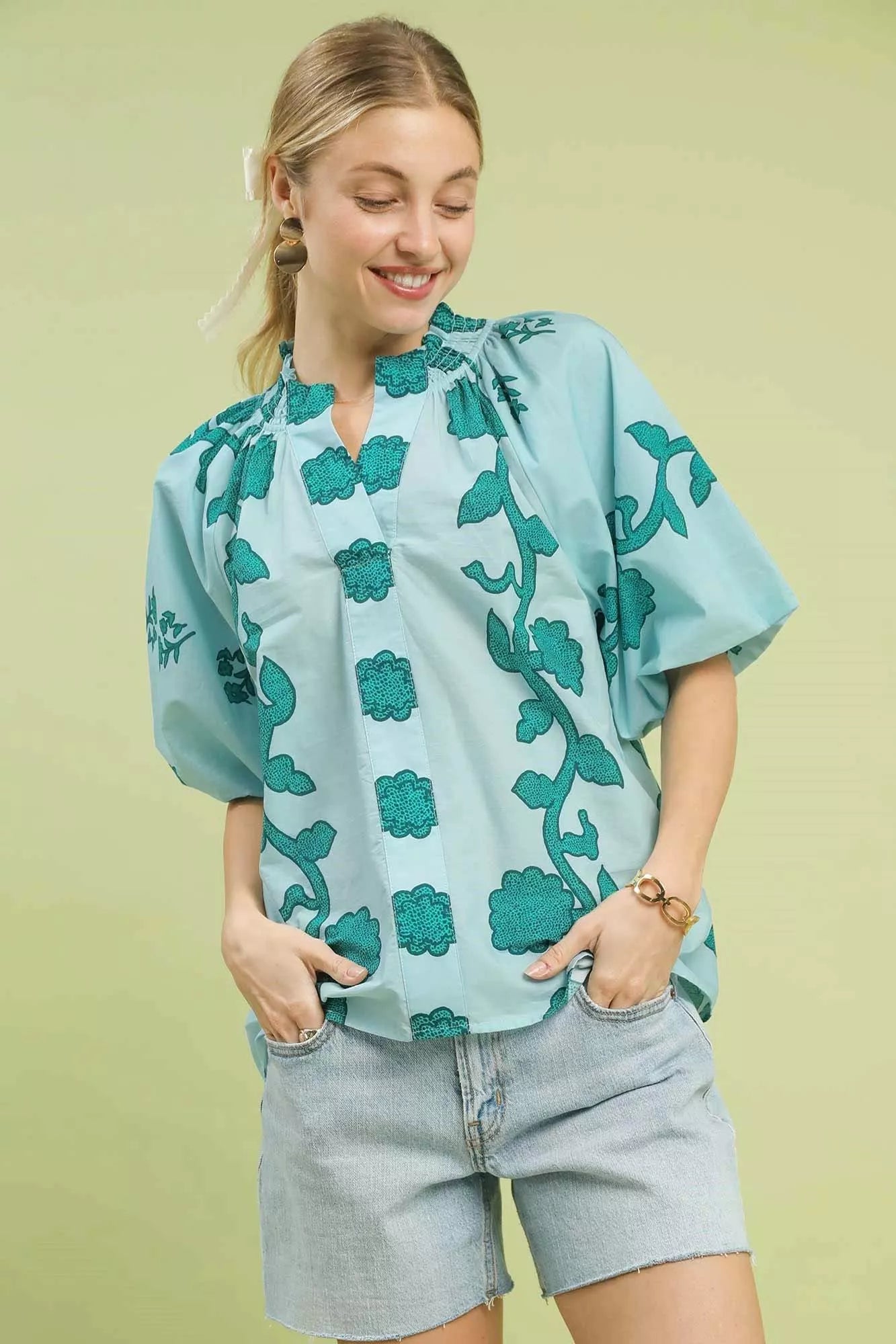 Women's teal cotton blouse with smocked neckline, floral print, short puff sleeves