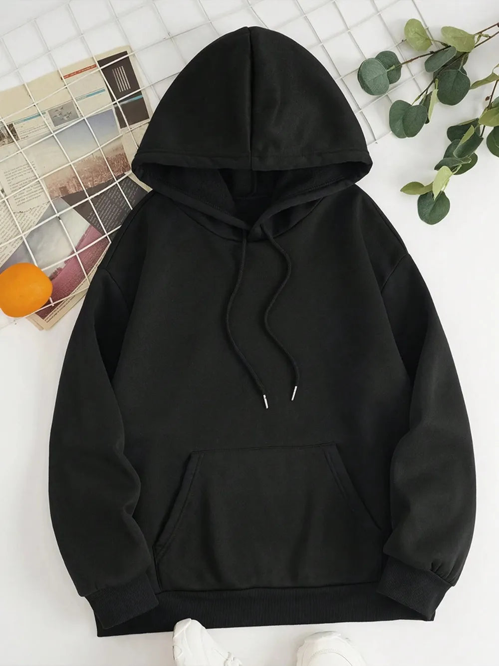 Black pullover hoodie with drawstring hood, long sleeves, and front kangaroo pocket