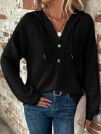 Black waffle-knit button hoodie with hood, long sleeves, and snap front