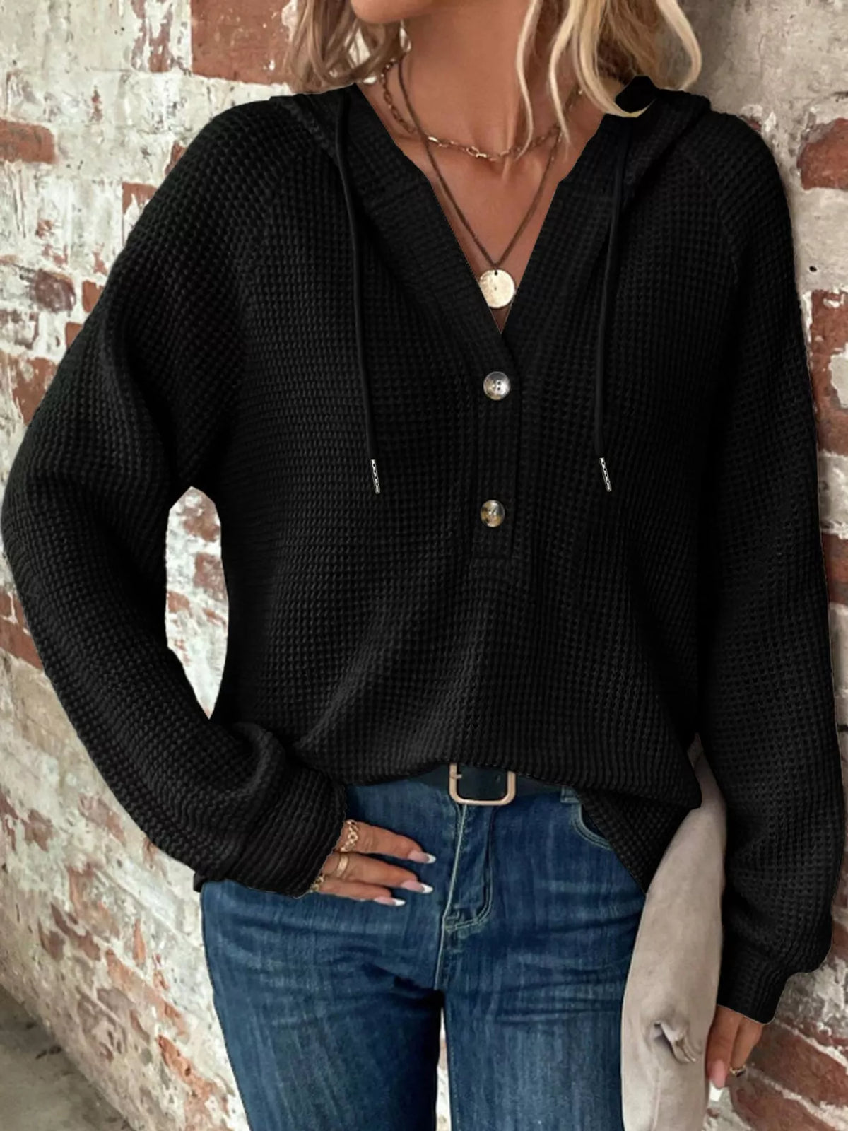 Black waffle-knit button hoodie with hood, long sleeves, and snap front