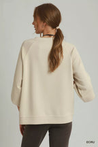 Ecru raglan sleeve round-hem top, back view with crew neckline and curved hem