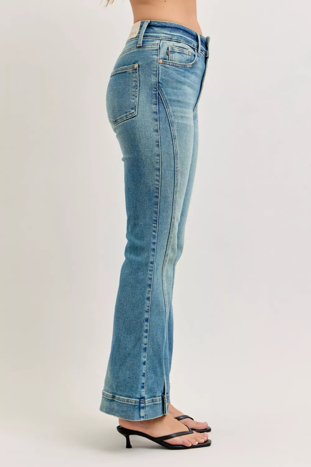 High-waist flare denim jeans in medium wash with stitched back yoke and pockets
