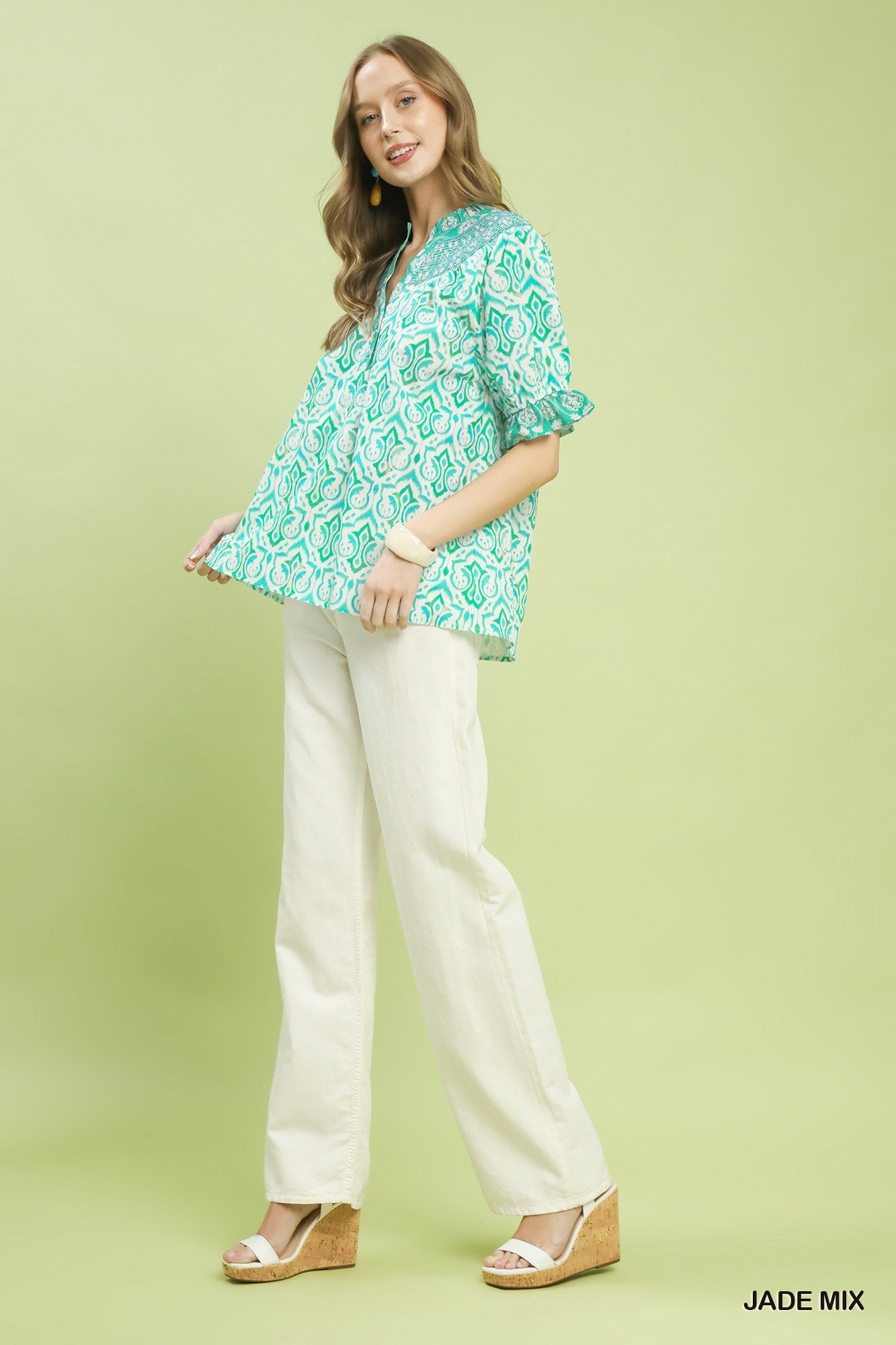Turquoise boho smocked top with puff sleeves and V-neck, geometric print