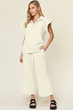 Cream ruffle sleeve top and wide-leg pants matching set, collared with shoulder ruffles