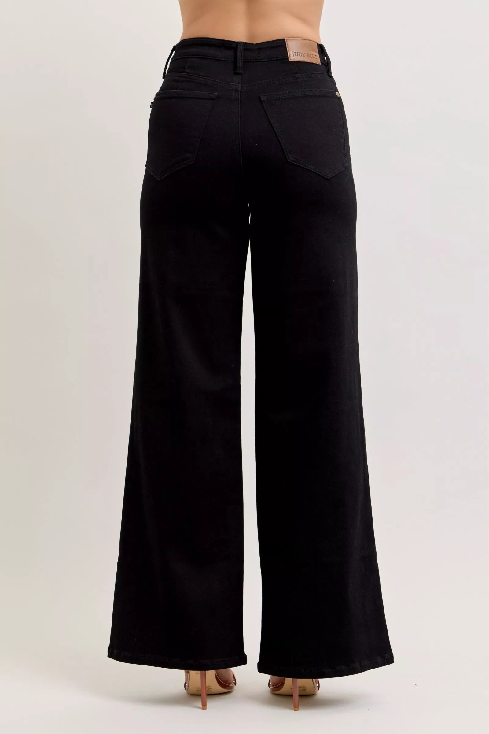 High-waisted wide-leg black denim jeans with front pockets and button closure