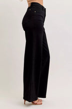 High-waisted wide-leg black denim jeans, side/back view with belt loops and pockets