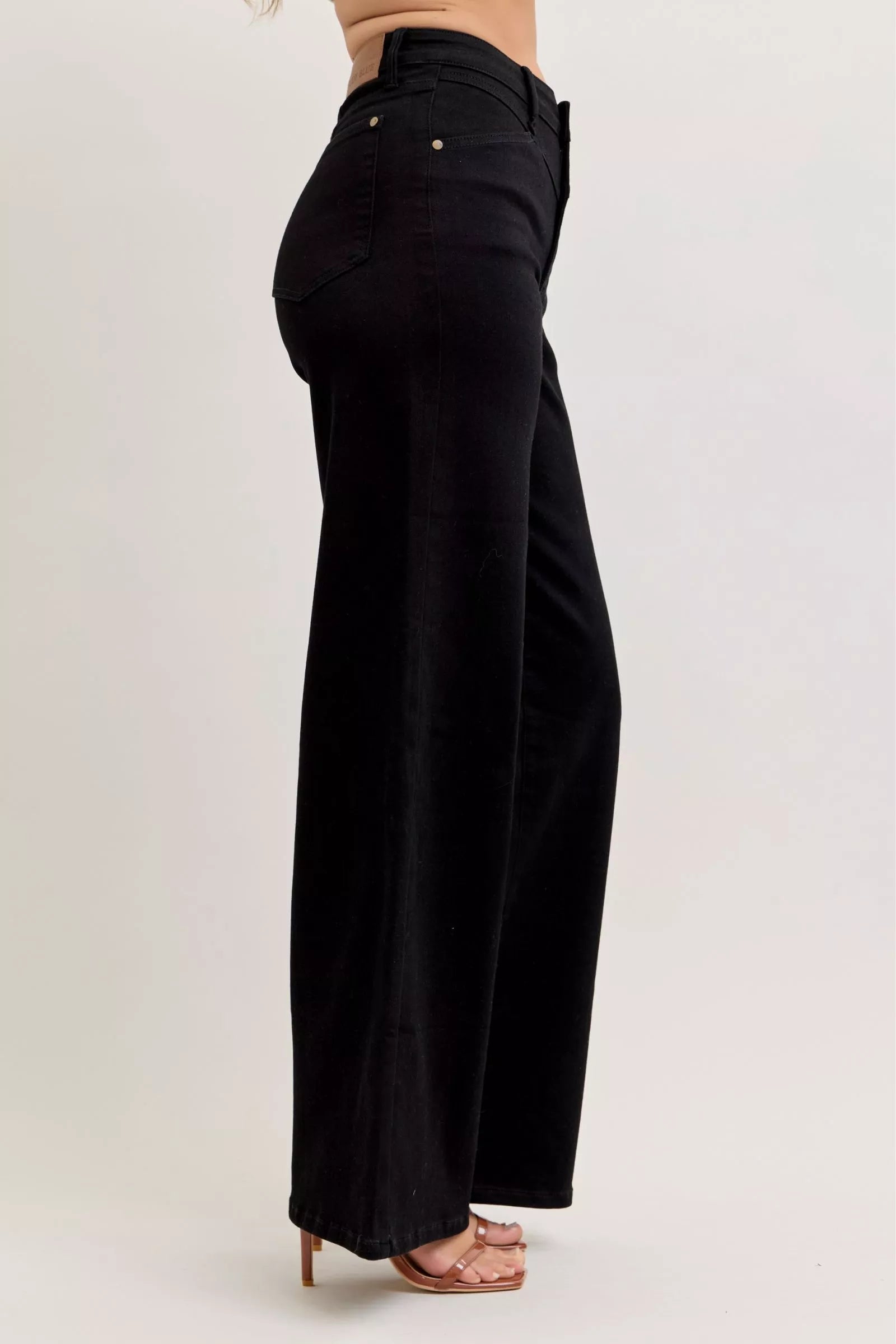 High-waisted wide-leg black denim jeans, side/back view with belt loops and pockets
