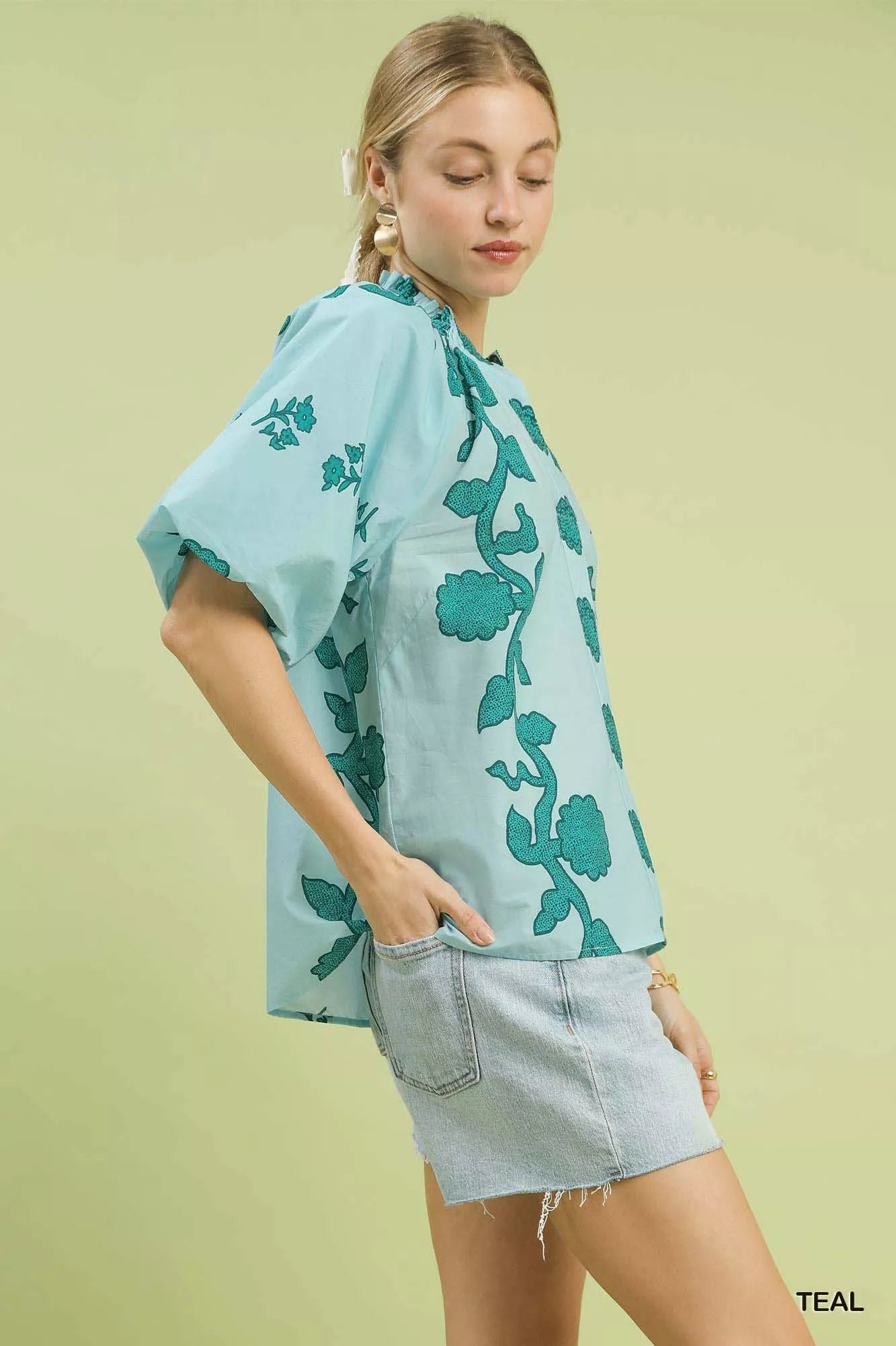 Women's teal floral cotton blouse with smocked neckline and short sleeves