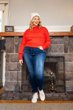 Dark blue skinny jeans with high-rise waist and tapered legs, worn