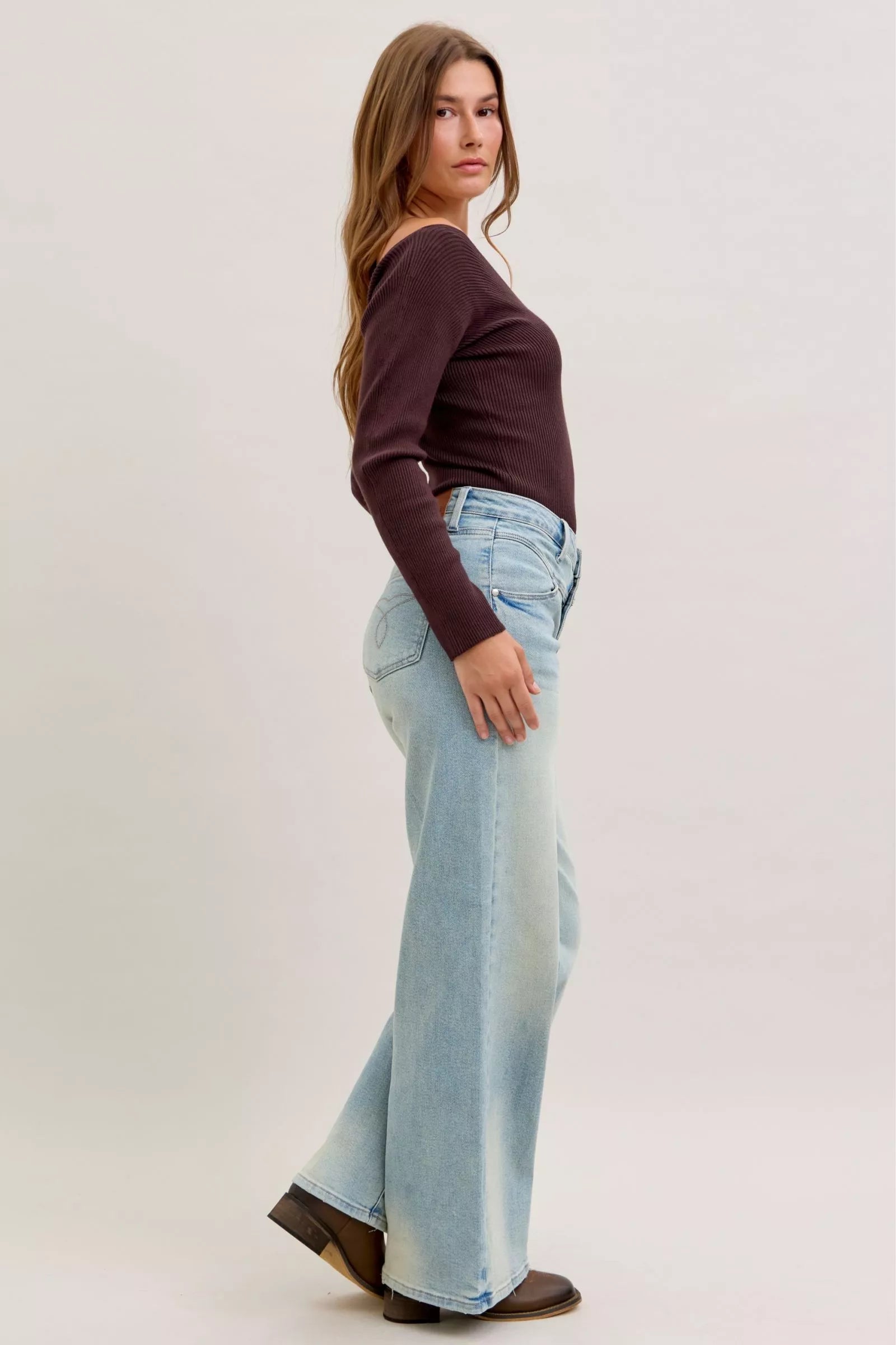Light blue high-waist straight jeans side view with belt loops and straight wide leg opening