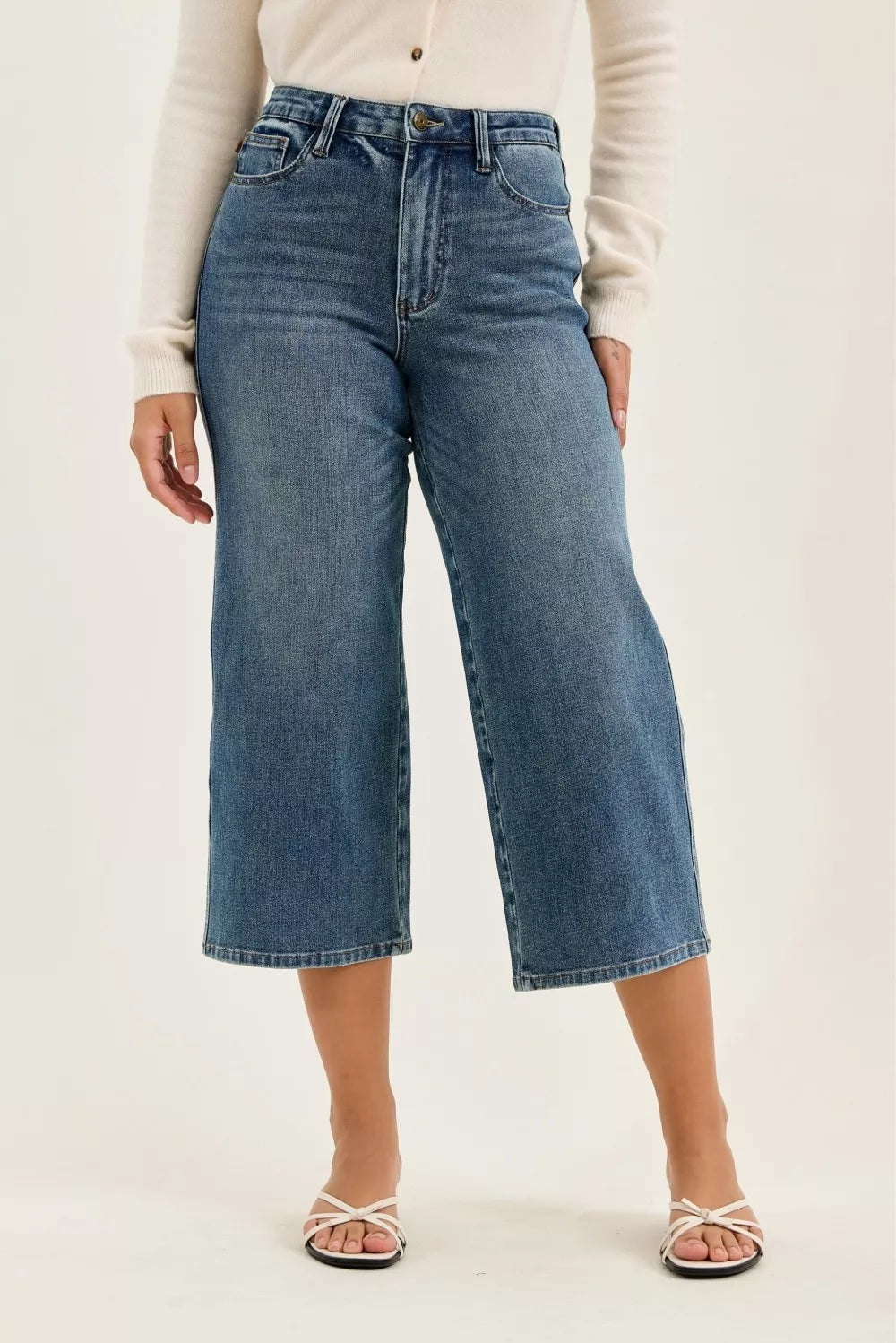 Mid-wash wide-crop jeans with front zipper, belt loops, and straight wide legs