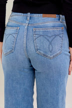 Light blue denim jeans close-up of back patch pockets with stitched detail