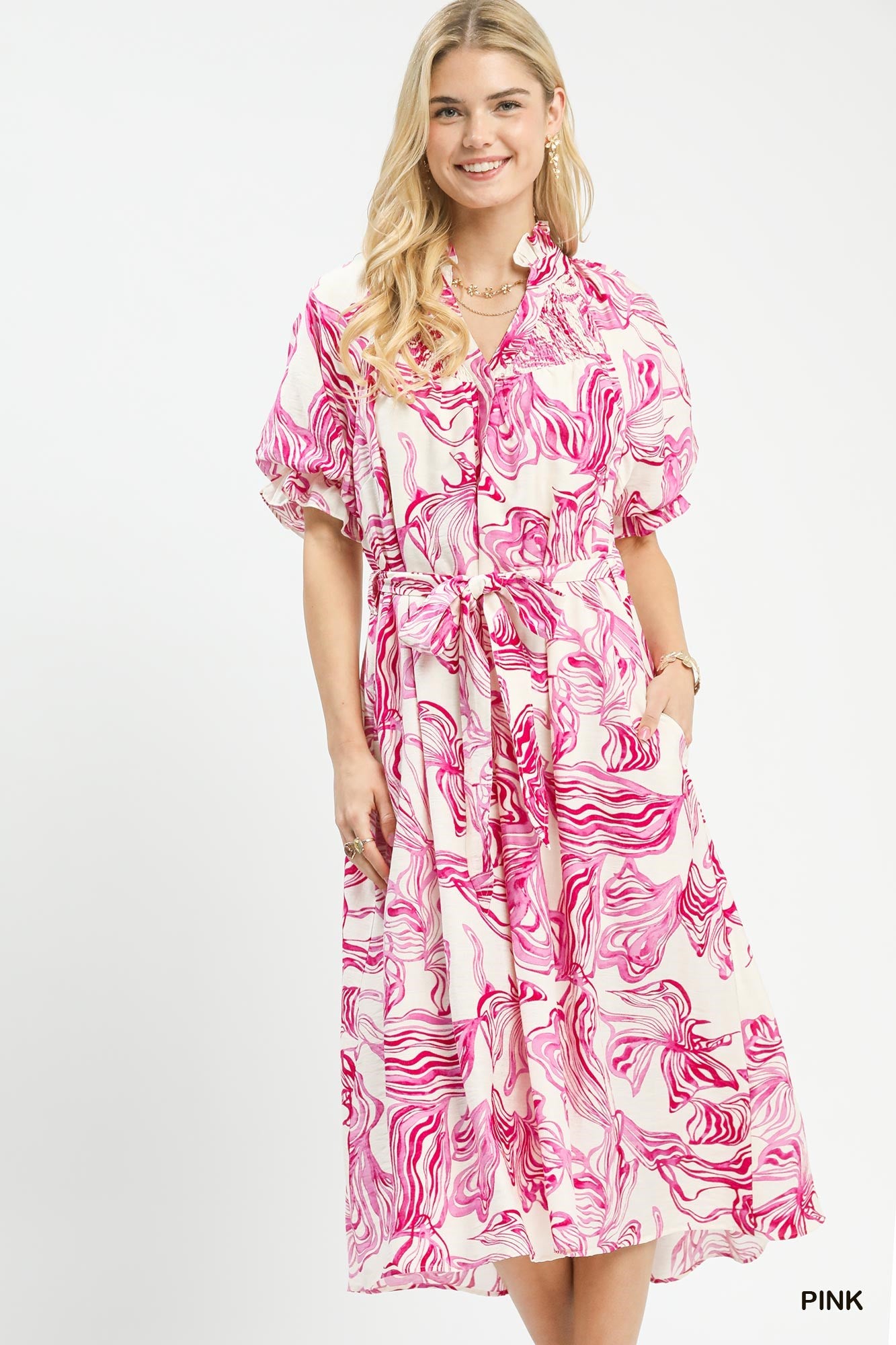 Pink abstract print midi dress with smocked V-neck, tie waist, and short puff sleeves