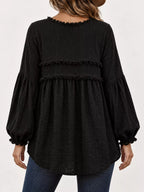 Black peplum blouse back view with frayed tiered ruffle trim and gathered balloon sleeves