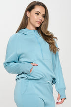 Light blue hooded quarter-zip hoodie with kangaroo pocket, front zipper
